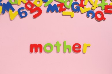 Photo of Word Mother made of magnetic letters on pink background, flat lay. Learning alphabet