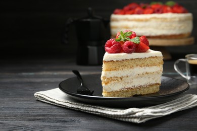 Photo of Piece of tasty sponge cake with fresh berries and mint served on black wooden table, space for text