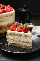 Photo of Tasty sponge cake with fresh berries and mint served on black table, closeup