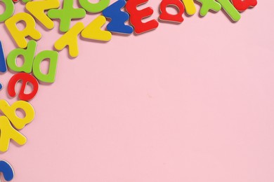 Learning alphabet. Magnetic letters on pink background, flat lay. Space for text