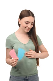 Photo of Expecting twins. Pregnant woman holding two paper cutouts of feet on white background