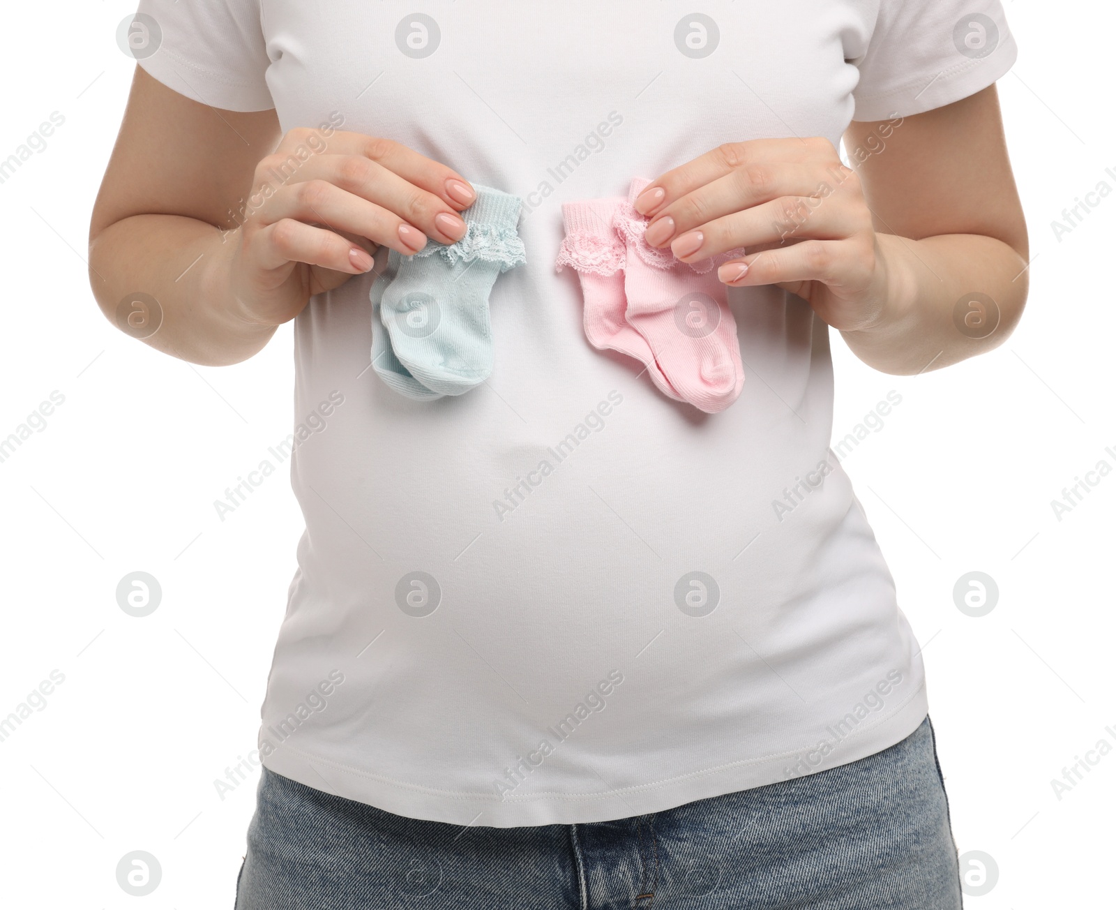 Photo of Expecting twins. Pregnant woman holding two pairs of socks on white background, closeup