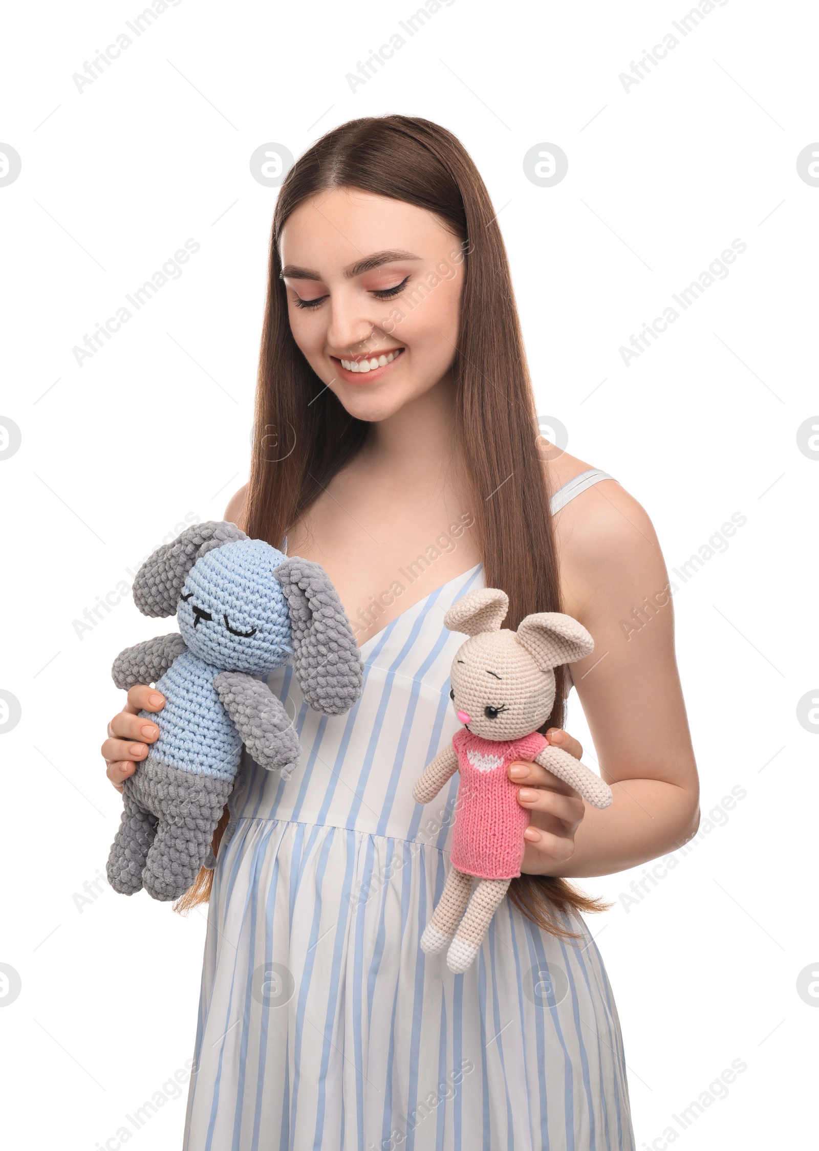 Photo of Expecting twins. Pregnant woman holding two toys on white background