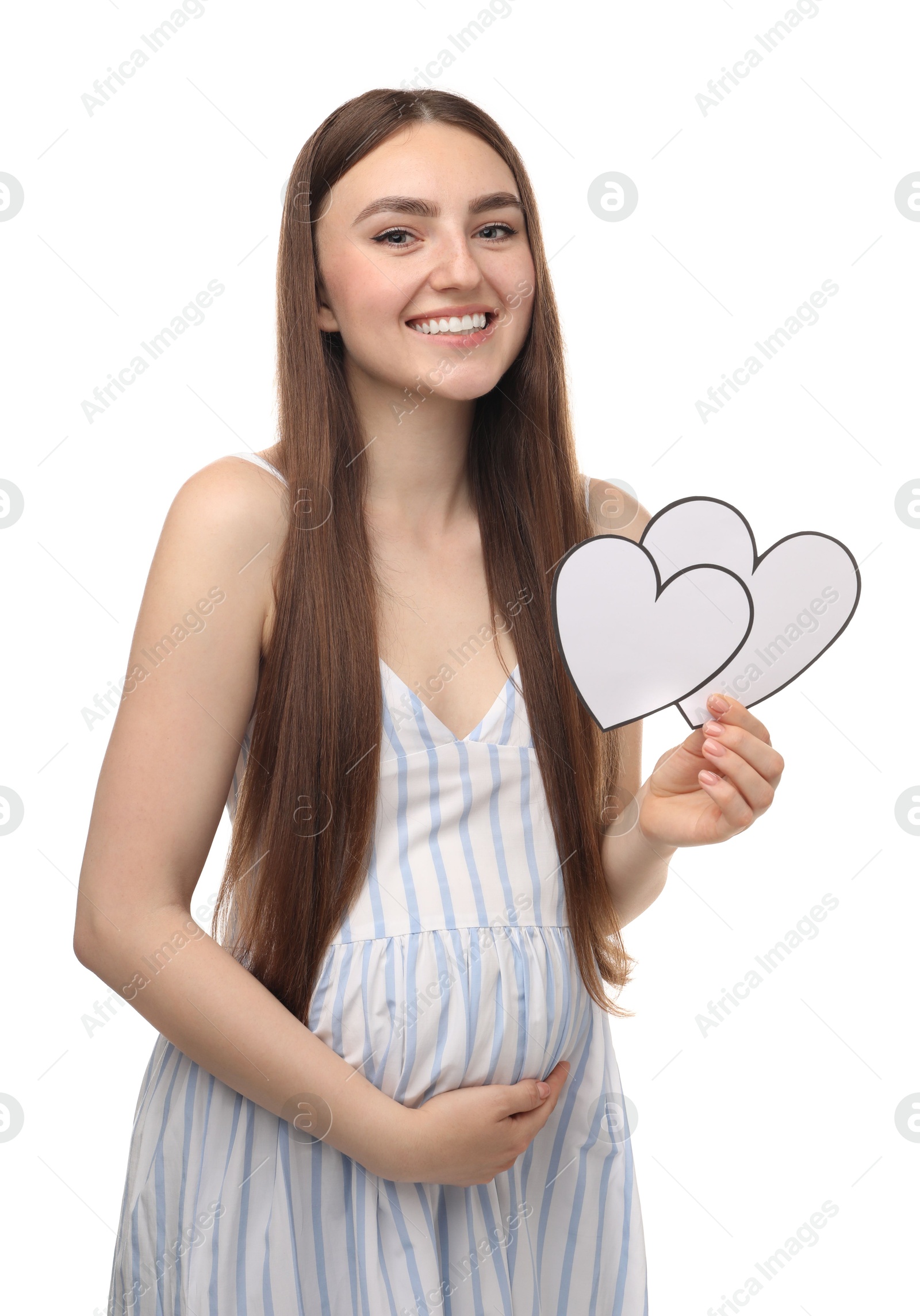 Photo of Expecting twins. Pregnant woman holding two paper cutouts of hearts on white background