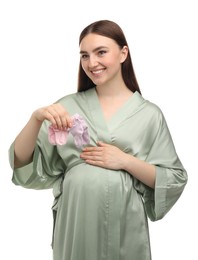 Photo of Expecting twins. Pregnant woman holding two pairs of socks on white background