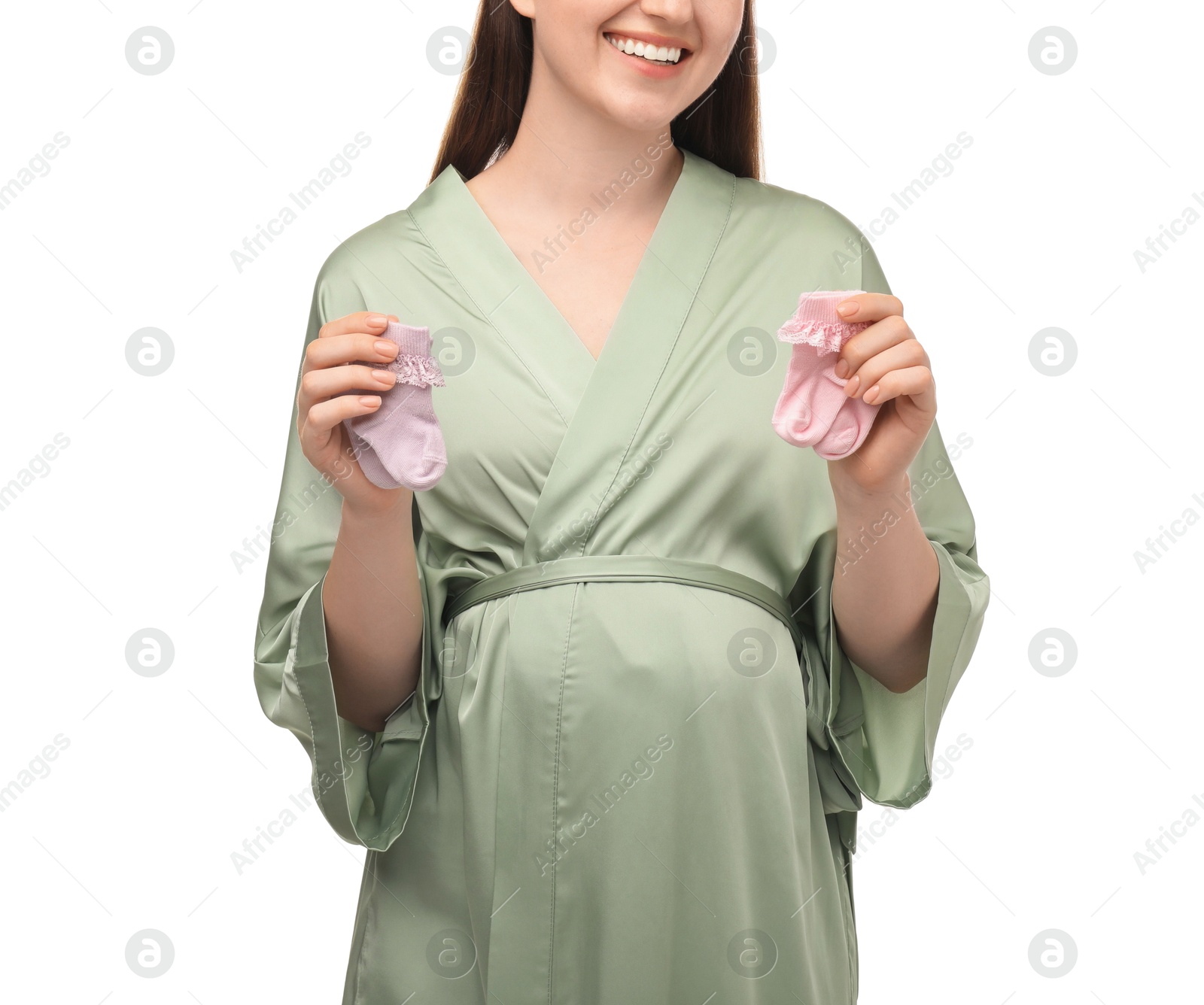 Photo of Expecting twins. Pregnant woman holding two pairs of socks on white background, closeup