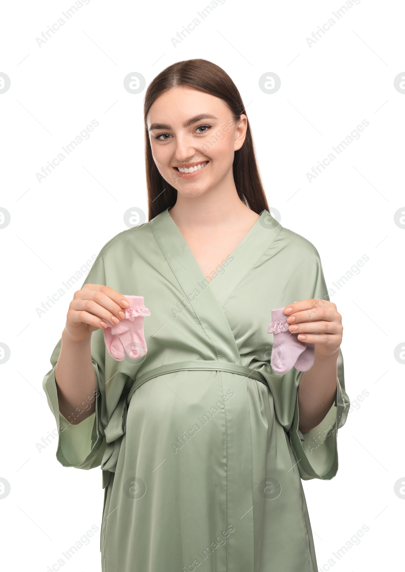 Photo of Expecting twins. Pregnant woman holding two pairs of socks on white background