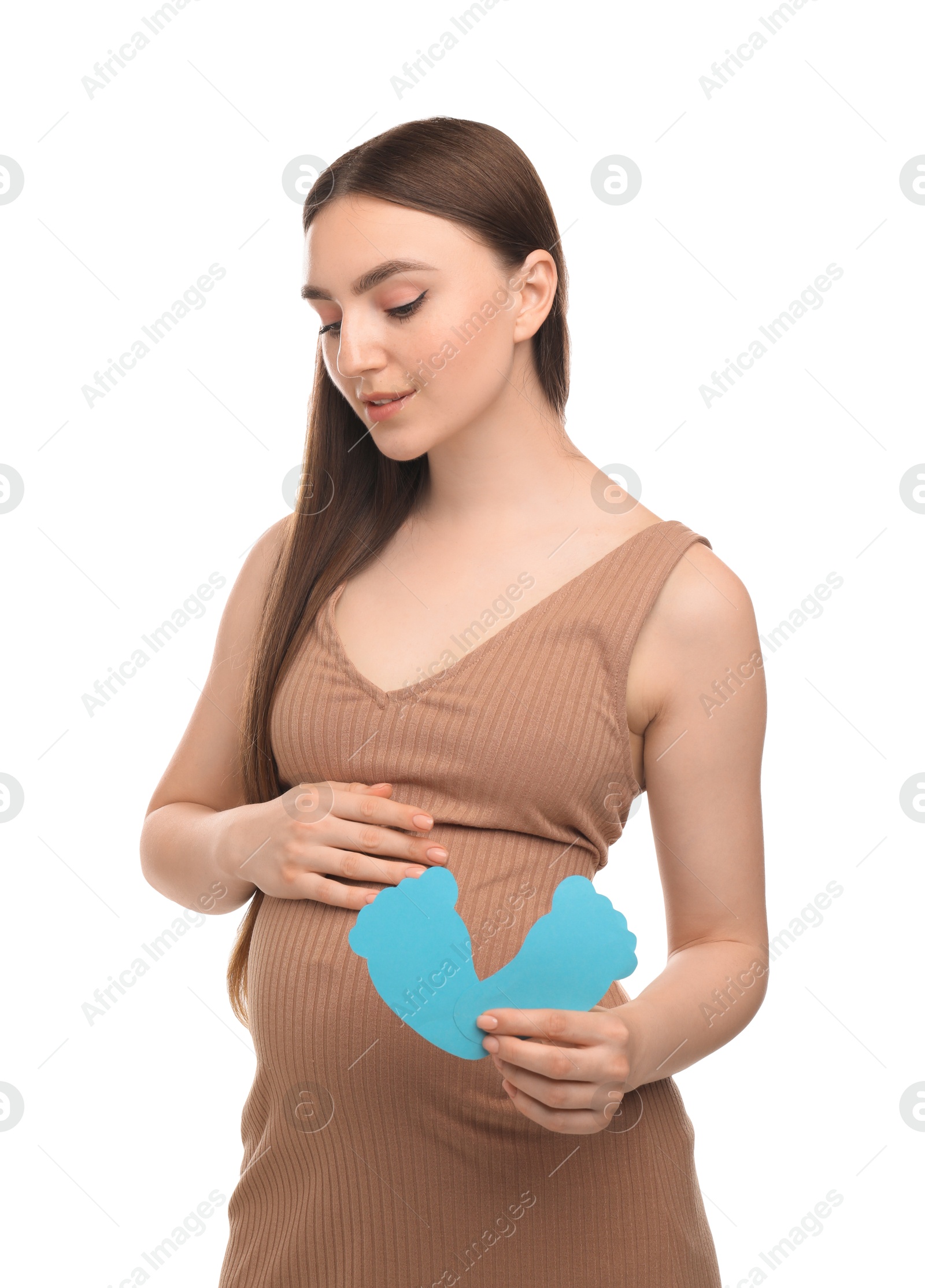 Photo of Expecting twins. Pregnant woman holding two paper cutouts of feet on white background