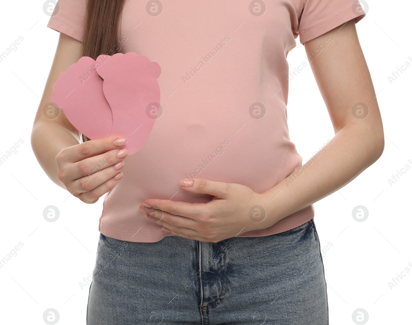 Photo of Expecting twins. Pregnant woman holding two paper cutouts of feet on white background, closeup