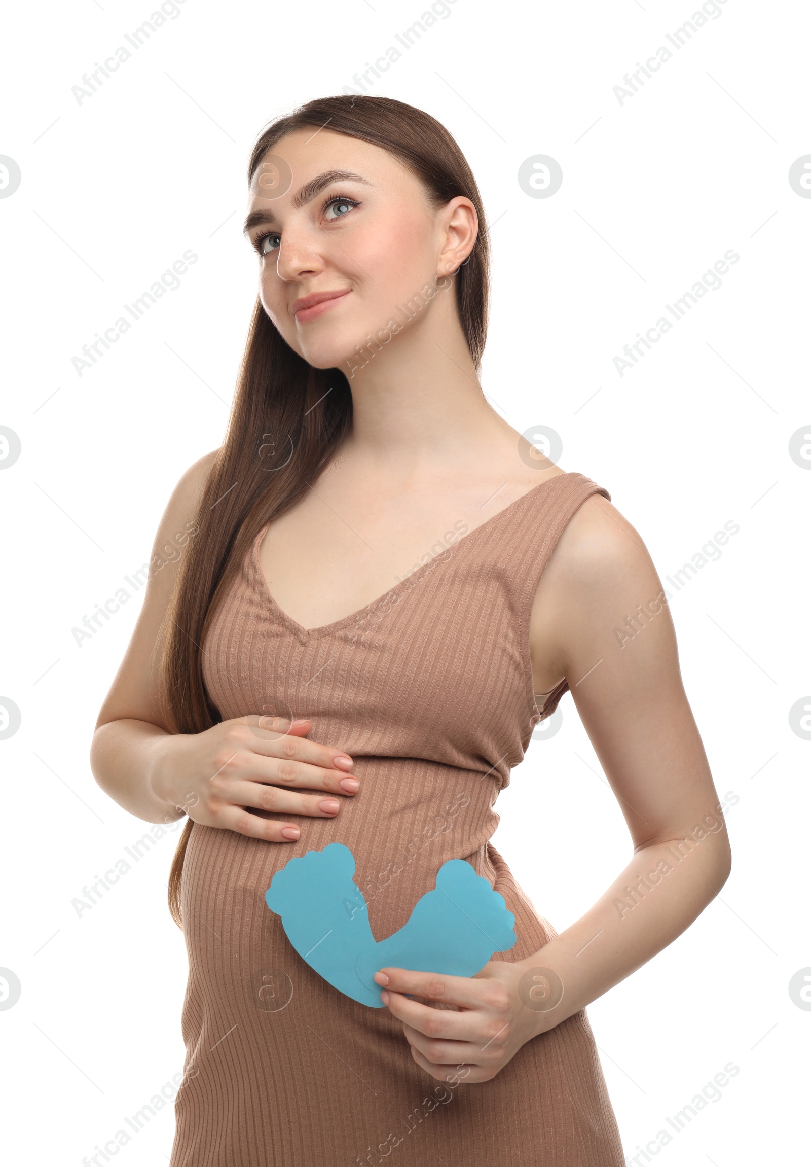 Photo of Expecting twins. Pregnant woman holding two paper cutouts of feet on white background