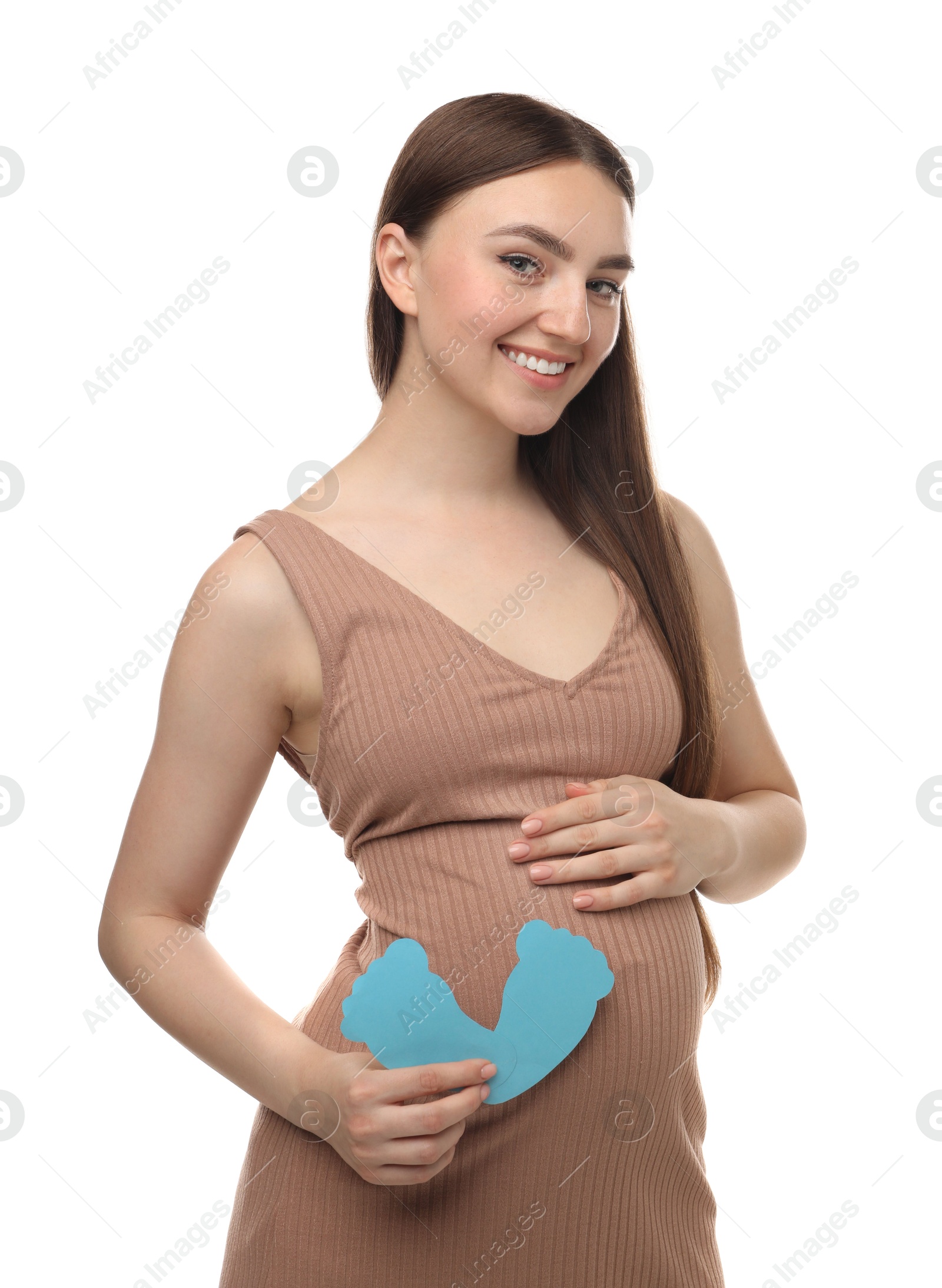 Photo of Expecting twins. Pregnant woman holding two paper cutouts of feet on white background