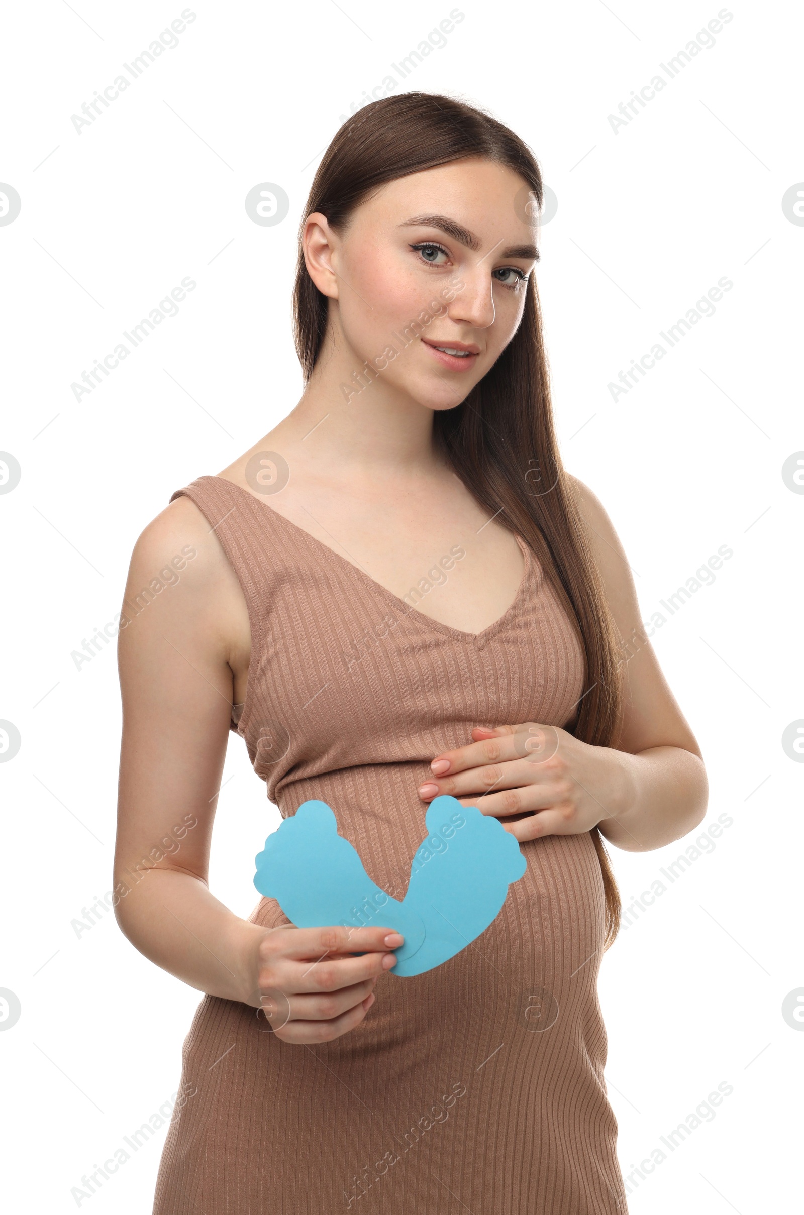 Photo of Expecting twins. Pregnant woman holding two paper cutouts of feet on white background