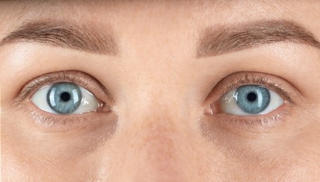 Woman with beautiful blue eyes, closeup view