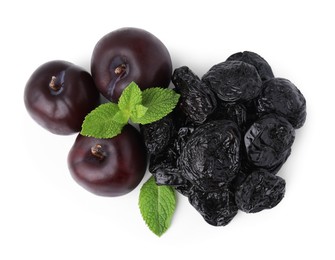 Delicious prunes, fresh ripe plums and mint isolated on white, top view