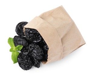 Photo of Paper bag with tasty dried plums (prunes) and mint isolated on white, top view