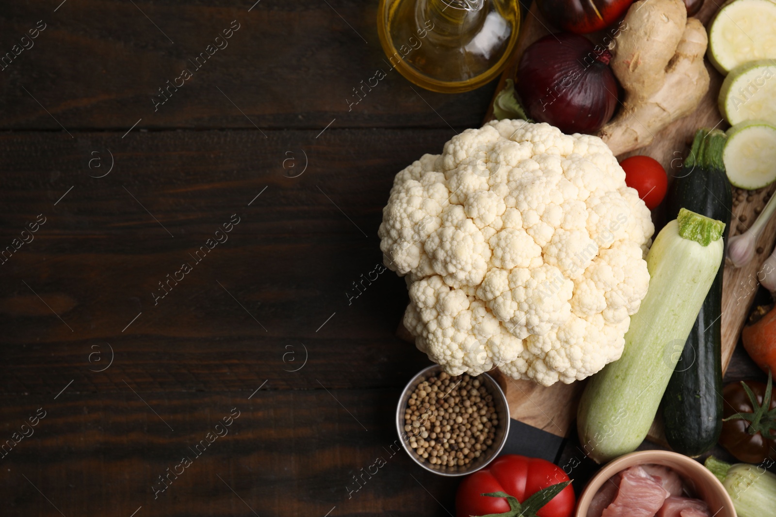 Photo of Different ingredients for stew on wooden table, top view. Space for text