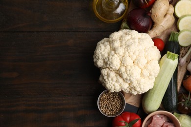 Different ingredients for stew on wooden table, top view. Space for text