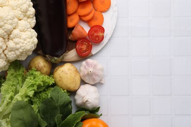 Cooking tasty stew. Different fresh vegetables on white tiled table, top view. Space for text