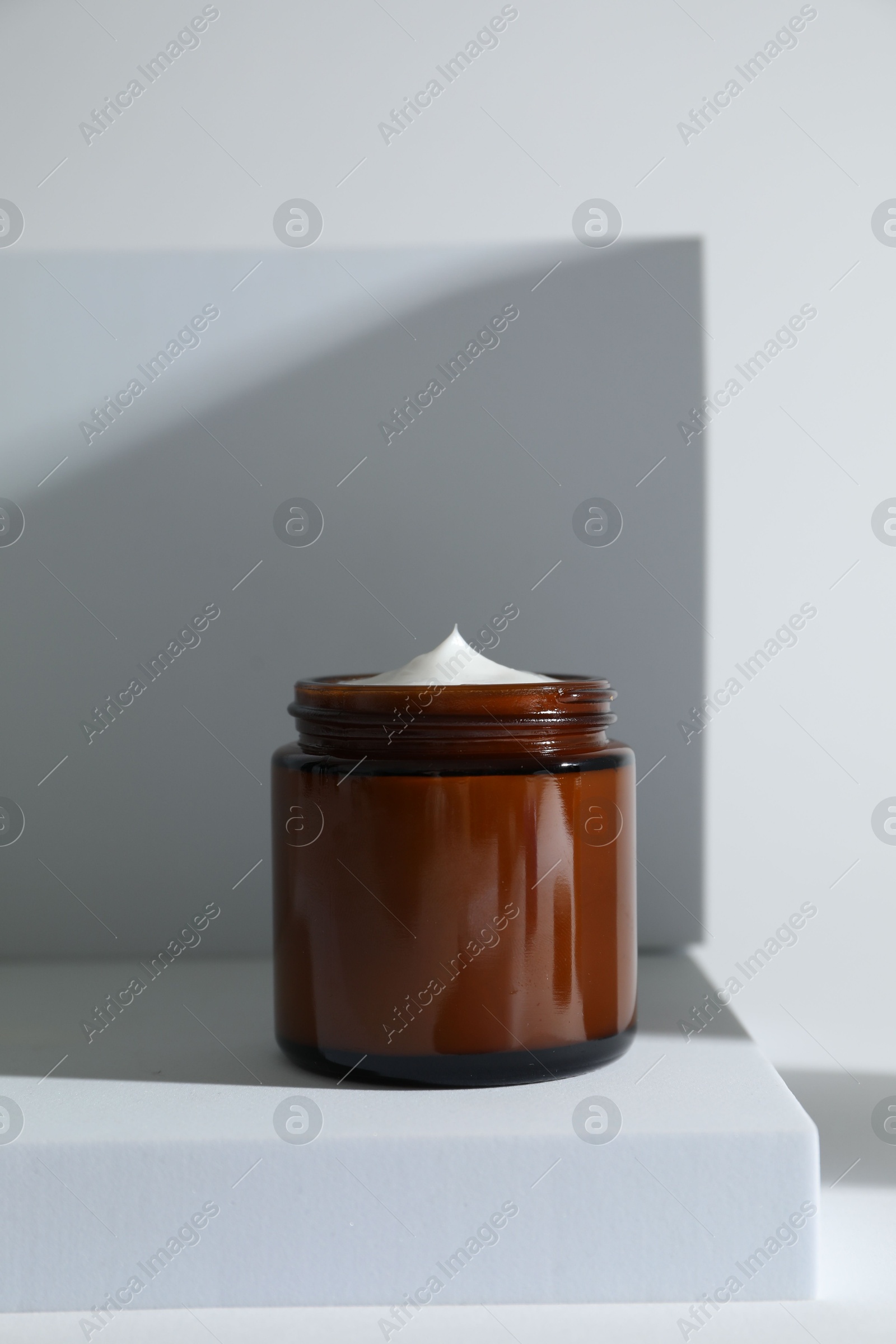 Photo of Stylish presentation of facial cream on white background