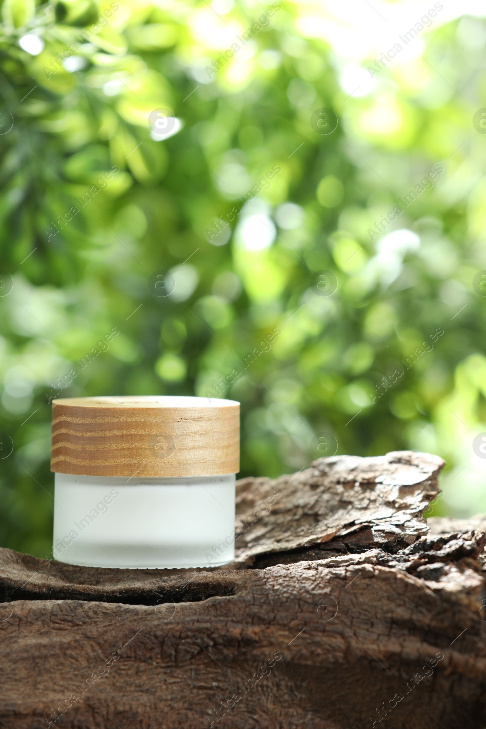 Photo of Stylish presentation of facial cream in jar outdoors