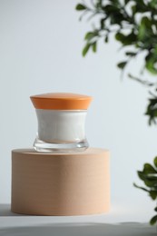 Photo of Stylish presentation of facial cream on white table