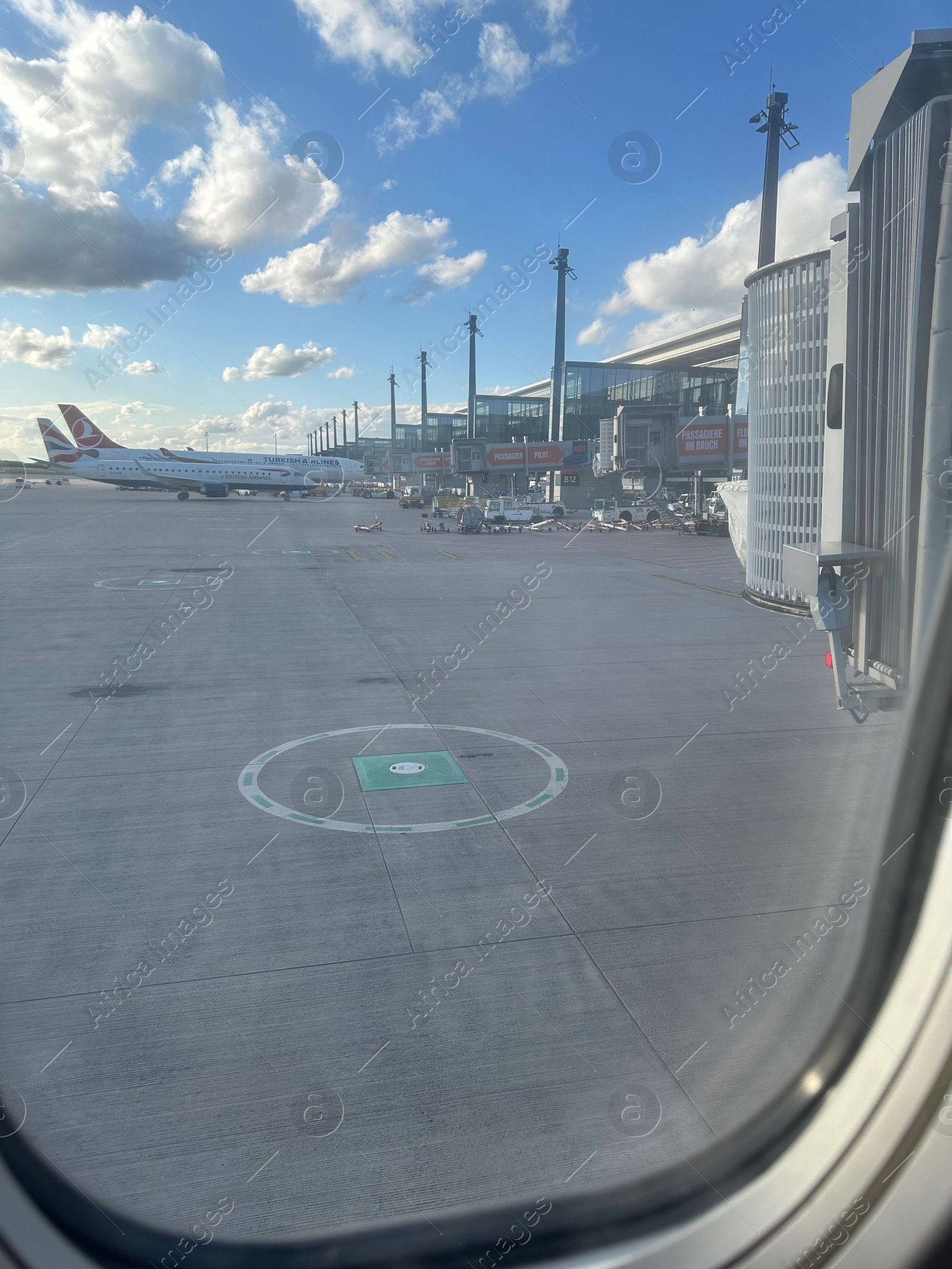 Photo of Berlin, Germany - July 3, 2024: Modern airplanes in Flughafen Berlin Brandenburg Airport, view from window