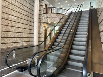 Photo of Modern escalators with handrails in shopping mall