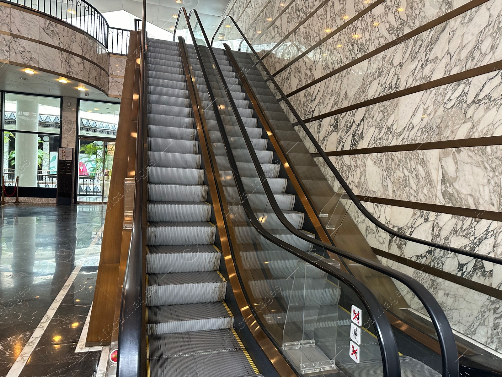 Photo of Modern escalators with handrails in shopping mall