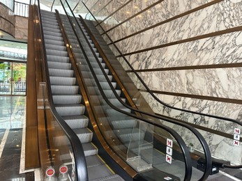 Photo of Modern escalators with handrails in shopping mall