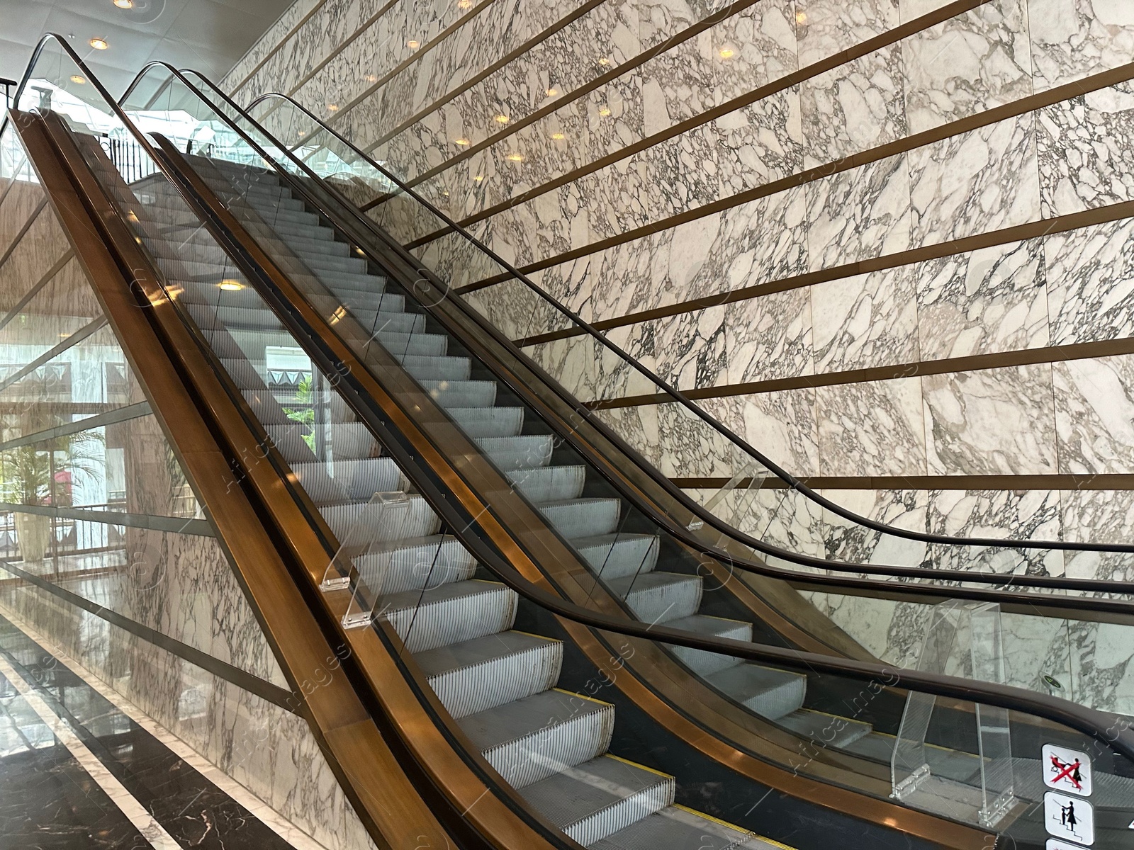 Photo of Modern escalators with handrails in shopping mall