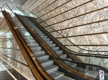 Modern escalators with handrails in shopping mall