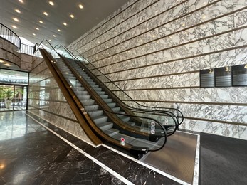 Photo of Modern escalators with handrails in shopping mall