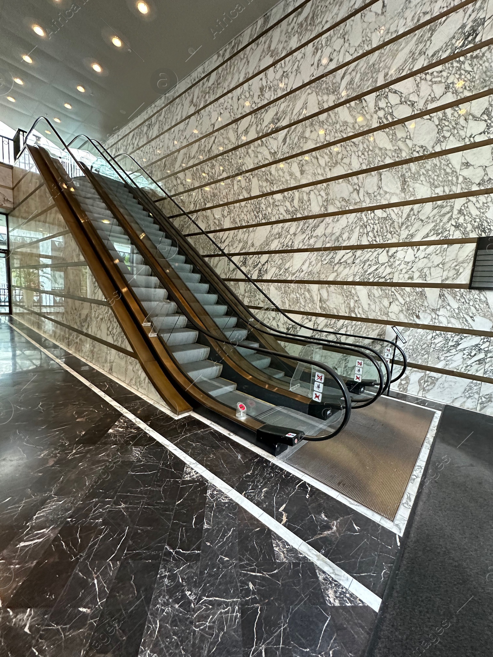 Photo of Modern escalators with handrails in shopping mall