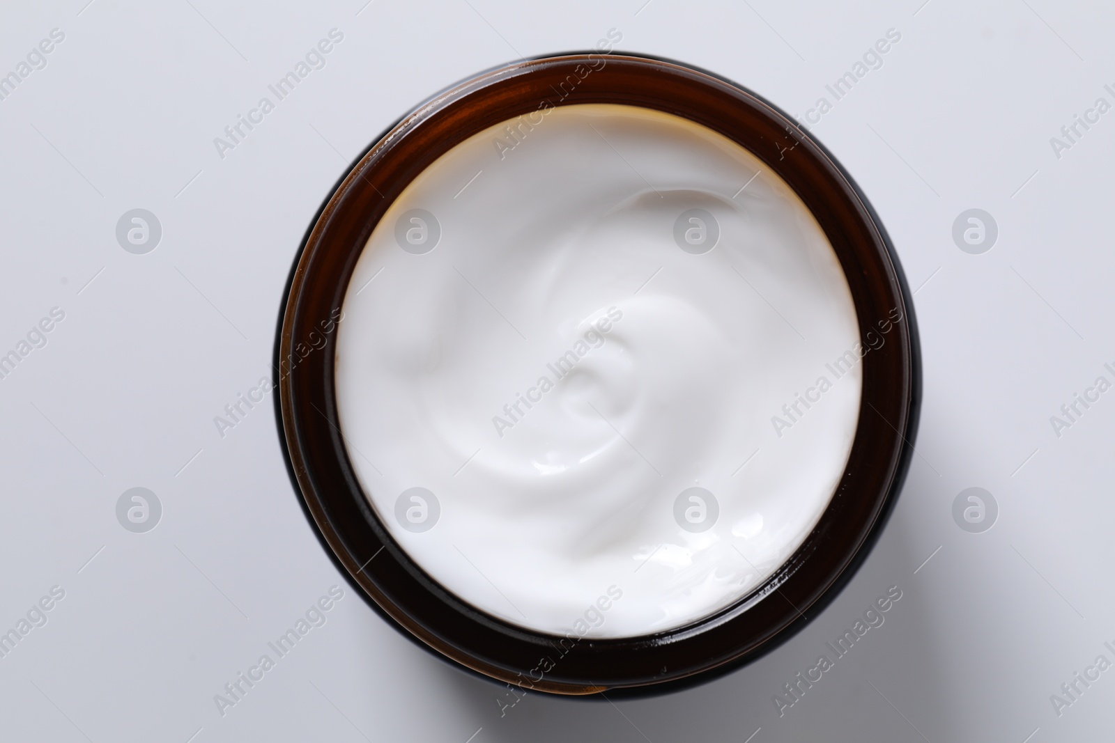 Photo of Face cream in jar on white background, top view