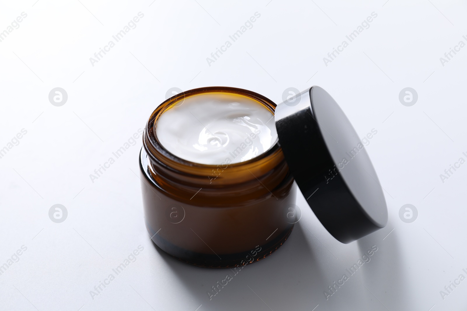 Photo of Face cream in jar on white background, closeup