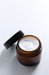 Photo of Face cream in jar on white background