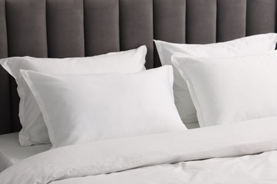 Many soft pillows on bed at home, closeup