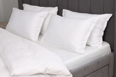 Many soft pillows on bed at home, closeup