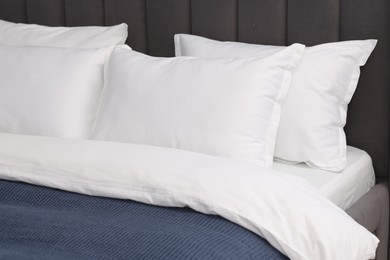 Many soft pillows on bed at home, closeup