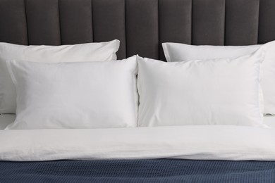 Many soft pillows on bed at home, closeup