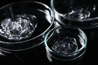 Photo of Petri dishes with samples on black mirror surface