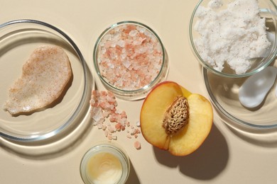 Photo of Petri dishes with different cosmetic products and peach on beige background, flat lay