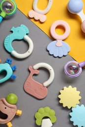 Photo of Different baby rattles on color background, flat lay