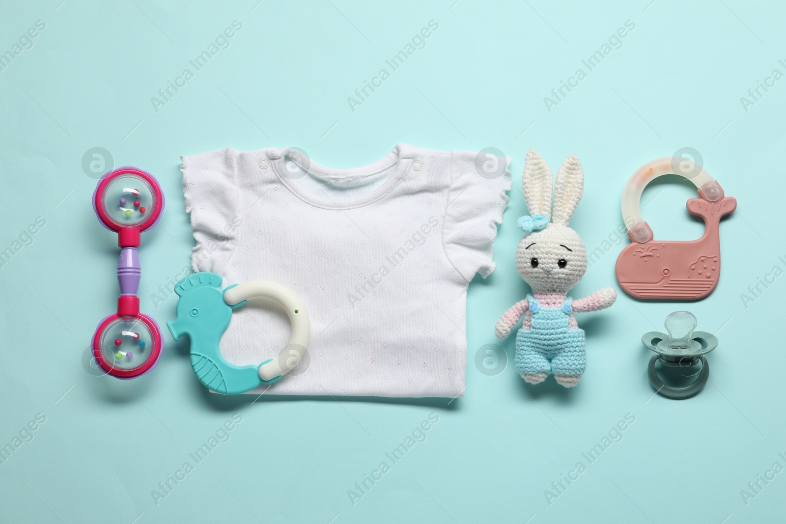 Photo of Baby accessories on light blue background, flat lay