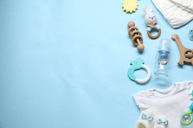 Photo of Different baby accessories on light blue background, flat lay. Space for text