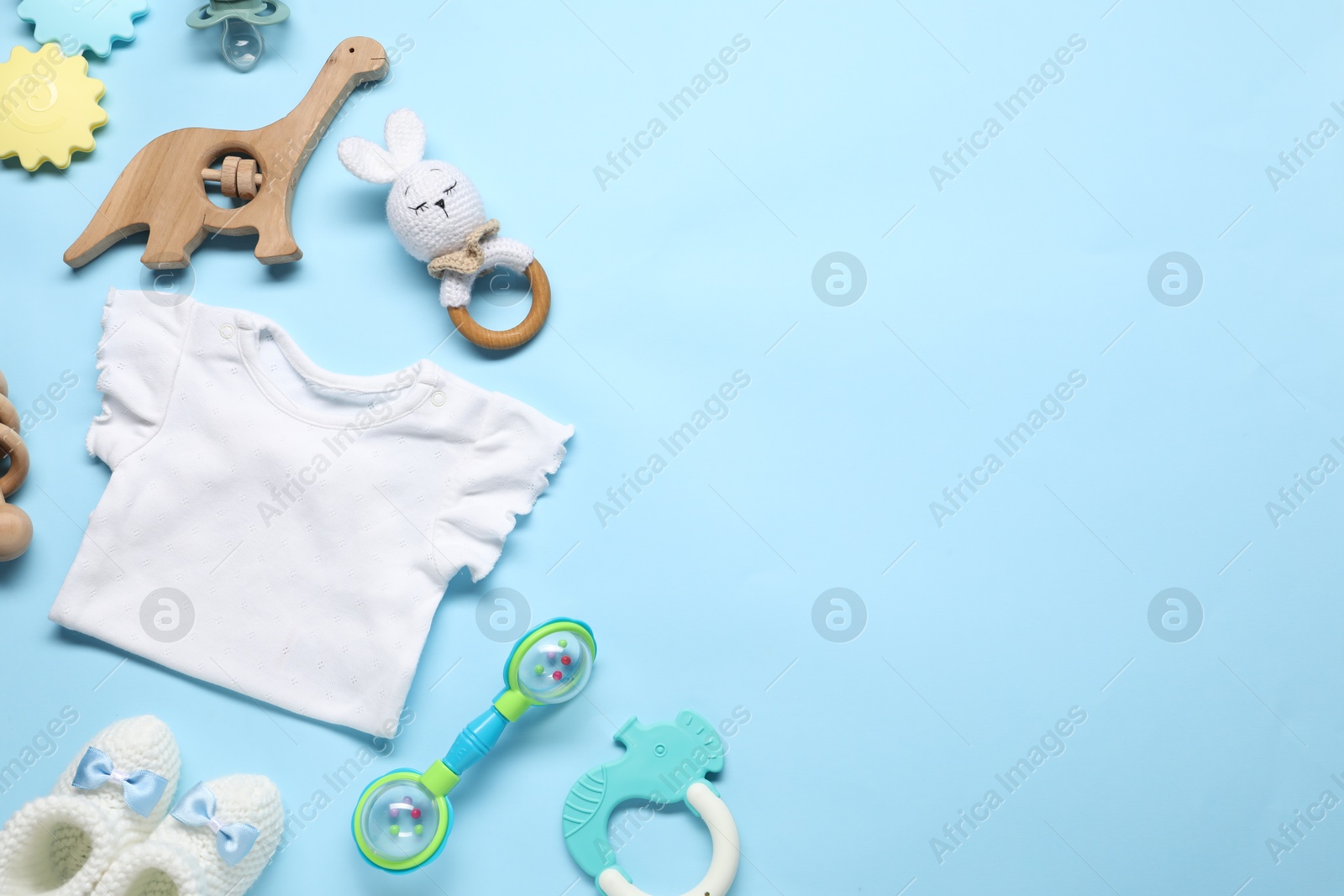 Photo of Different baby accessories on light blue background, flat lay. Space for text