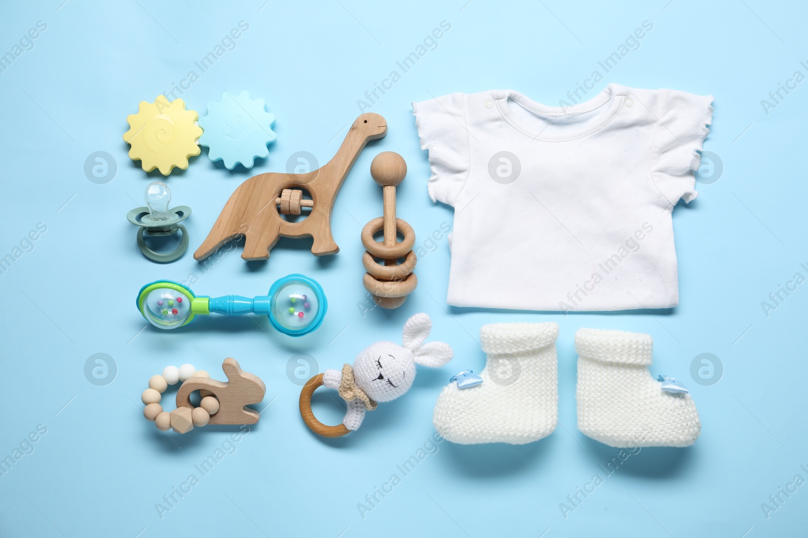 Photo of Different baby accessories on light blue background, flat lay