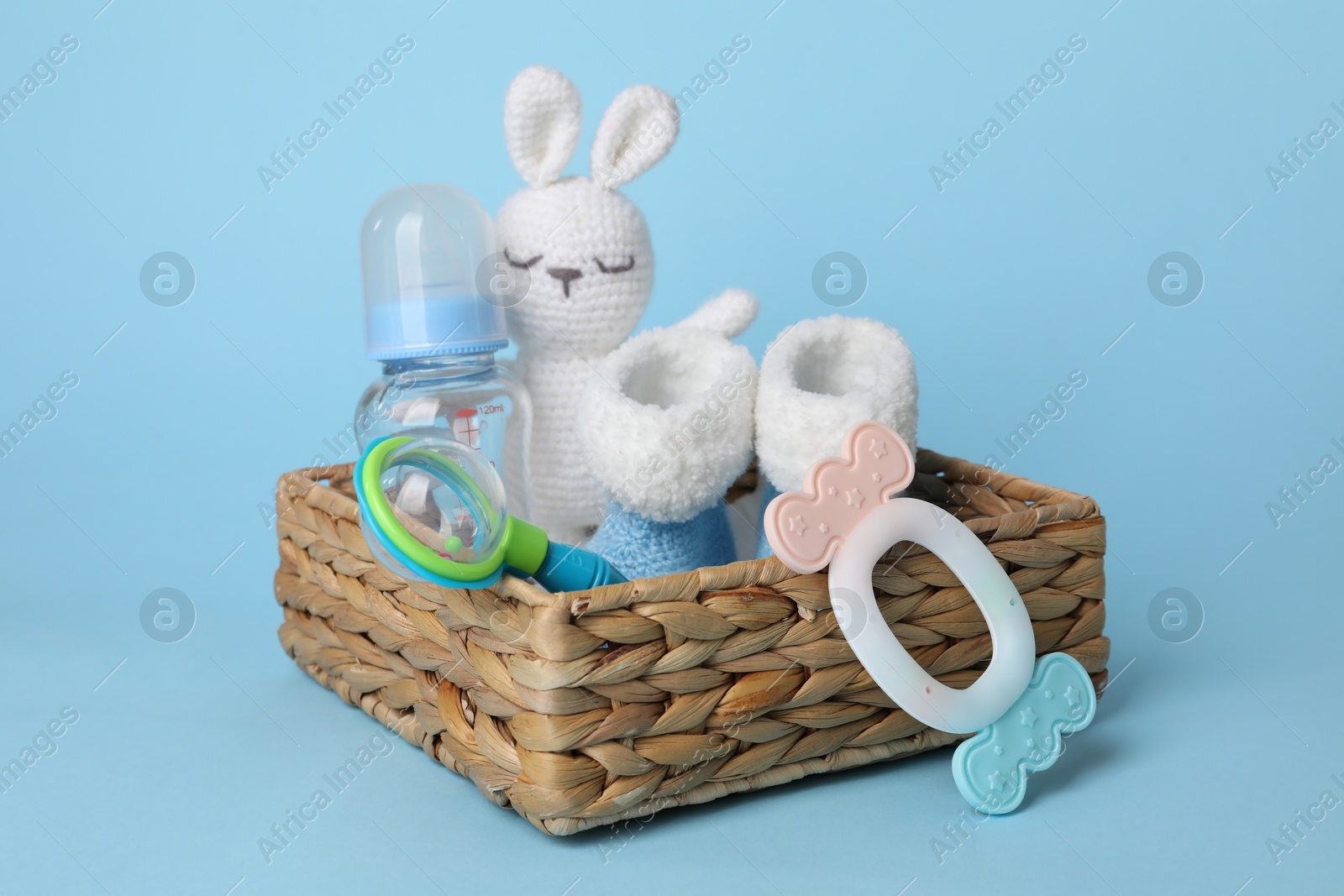 Photo of Baby accessories in box on light blue background