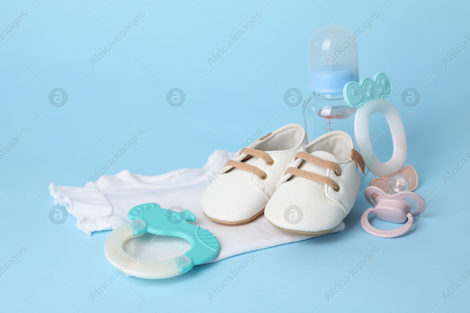 Photo of Different baby accessories on light blue background