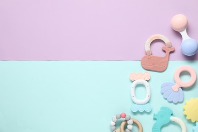 Photo of Different baby rattles on color background, flat lay. Space for text